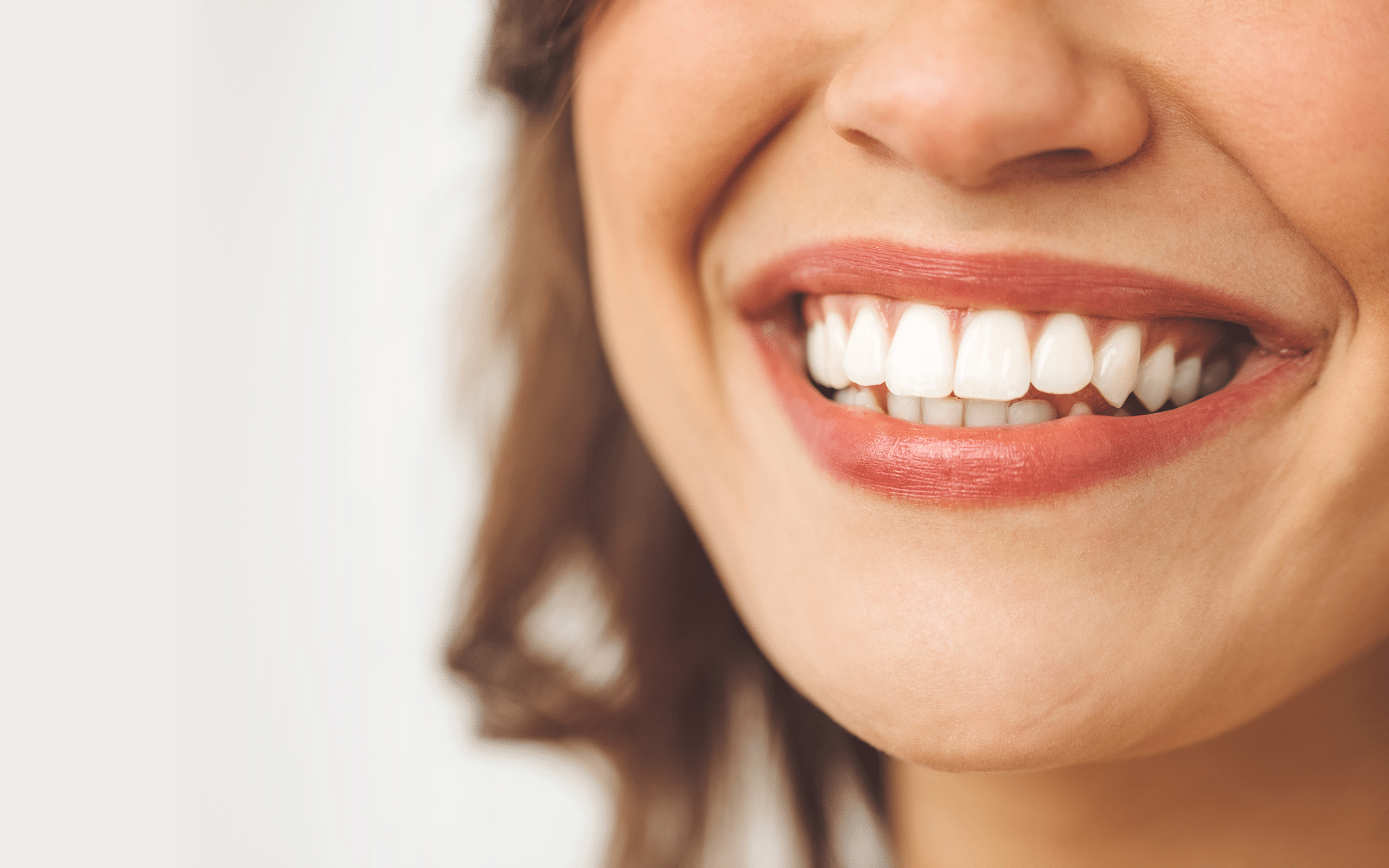 Bottom half of woman's smiling face.